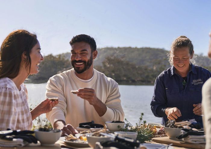 Friends enjoying oysters on a Kayak and Shuck tour with Navigate Expeditions, Pambula River